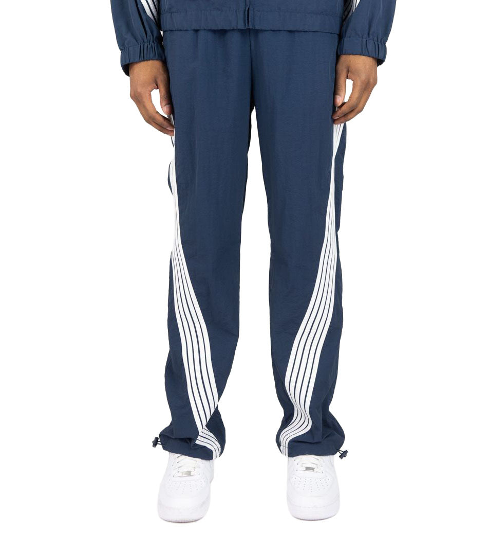 Navy Rebel Minds Stripe Nylon Pants worn by a person on a white background