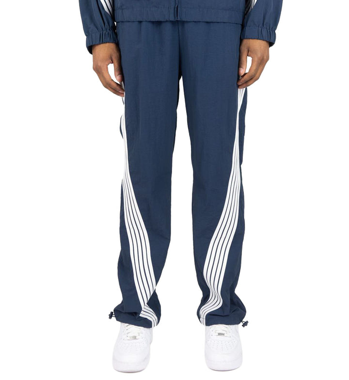 Navy Rebel Minds Stripe Nylon Pants worn by a person on a white background