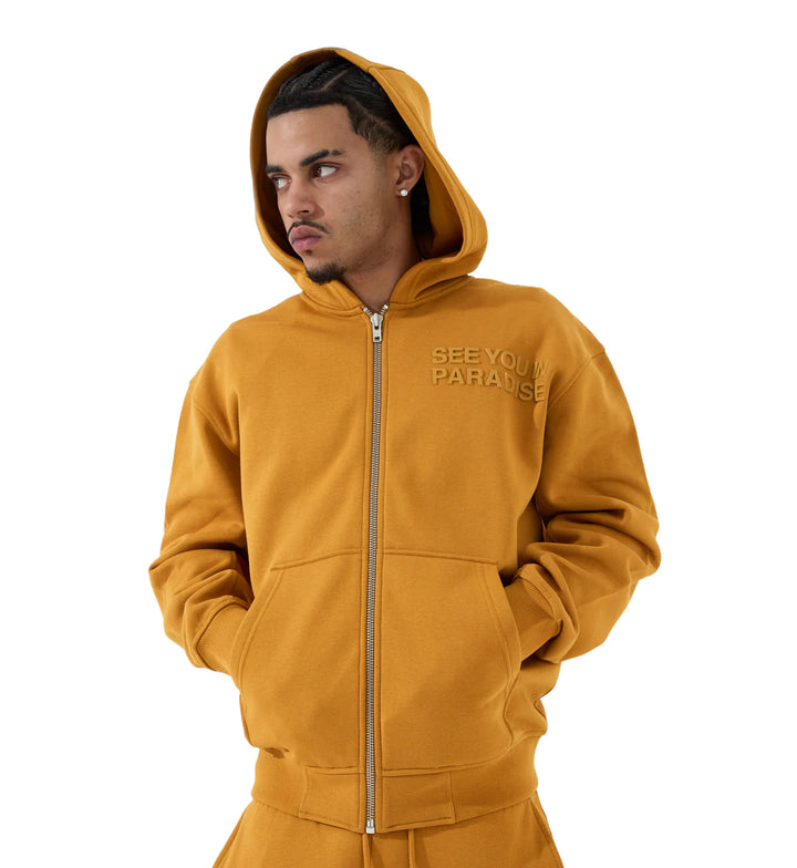 Man wearing a SYIP Tonal Zip Up Hoodie — Cognac with "See You In Paradise" text 