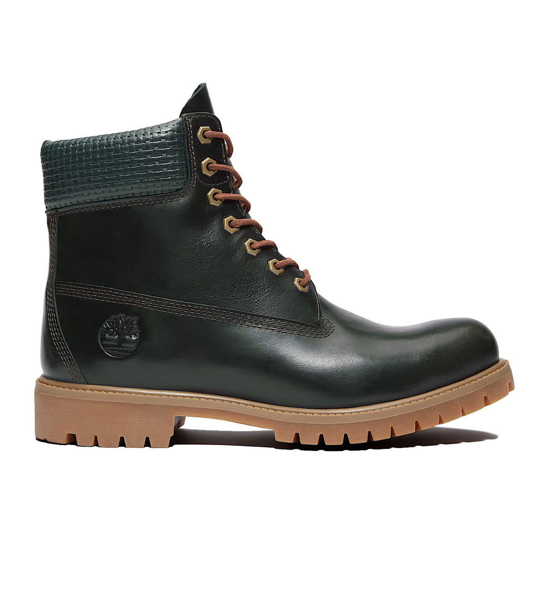 Green leather Timberland boot with brown sole on a white background