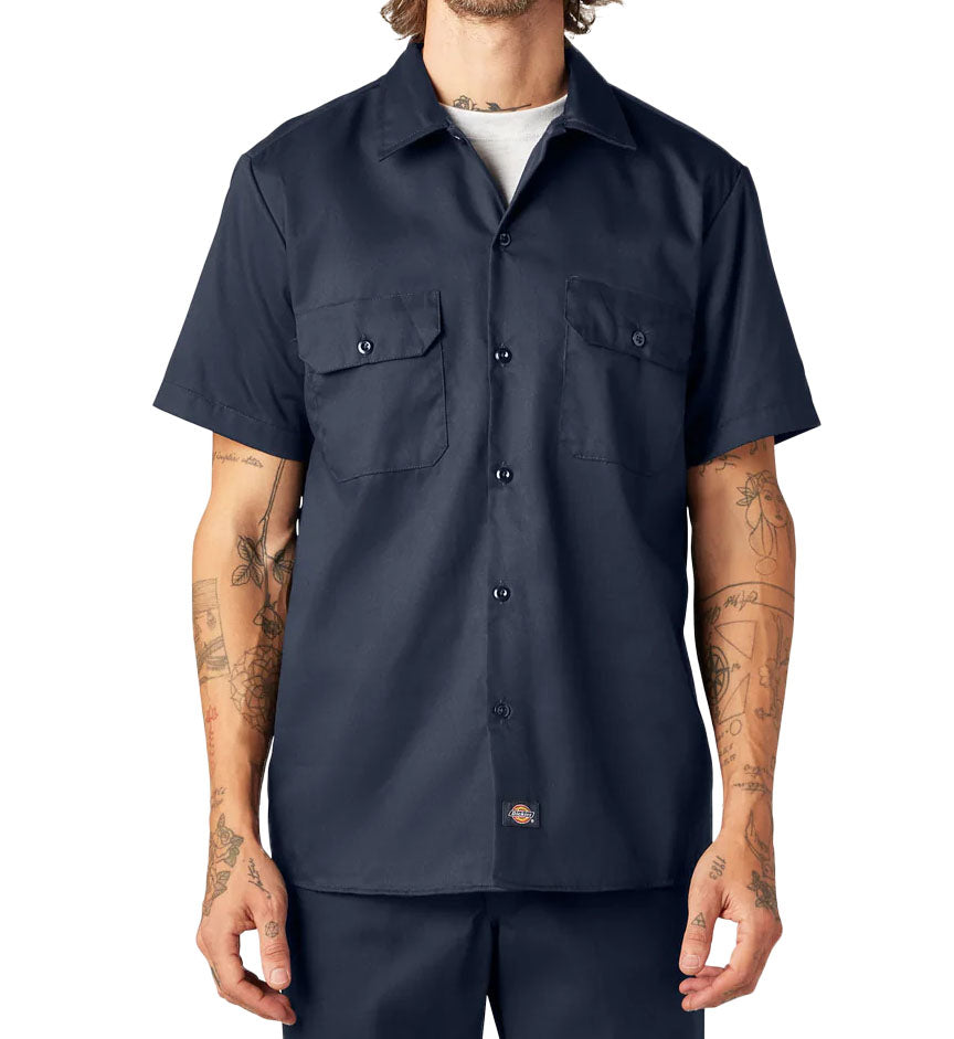 Man wearing a navy Dickies FLEX Slim Fit Short Sleeve Work Shirt against a white background