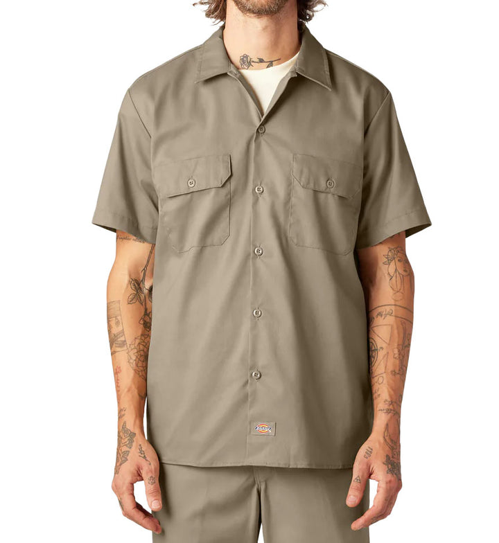 Man wearing a Dickies FLEX Slim Fit Short Sleeve Work Shirt in Desert Sand against a white background