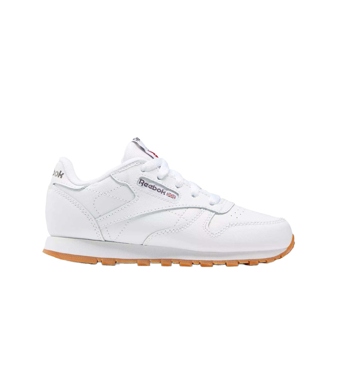Preschool white with gum sole Reebok Classic Leather shoe on white background.