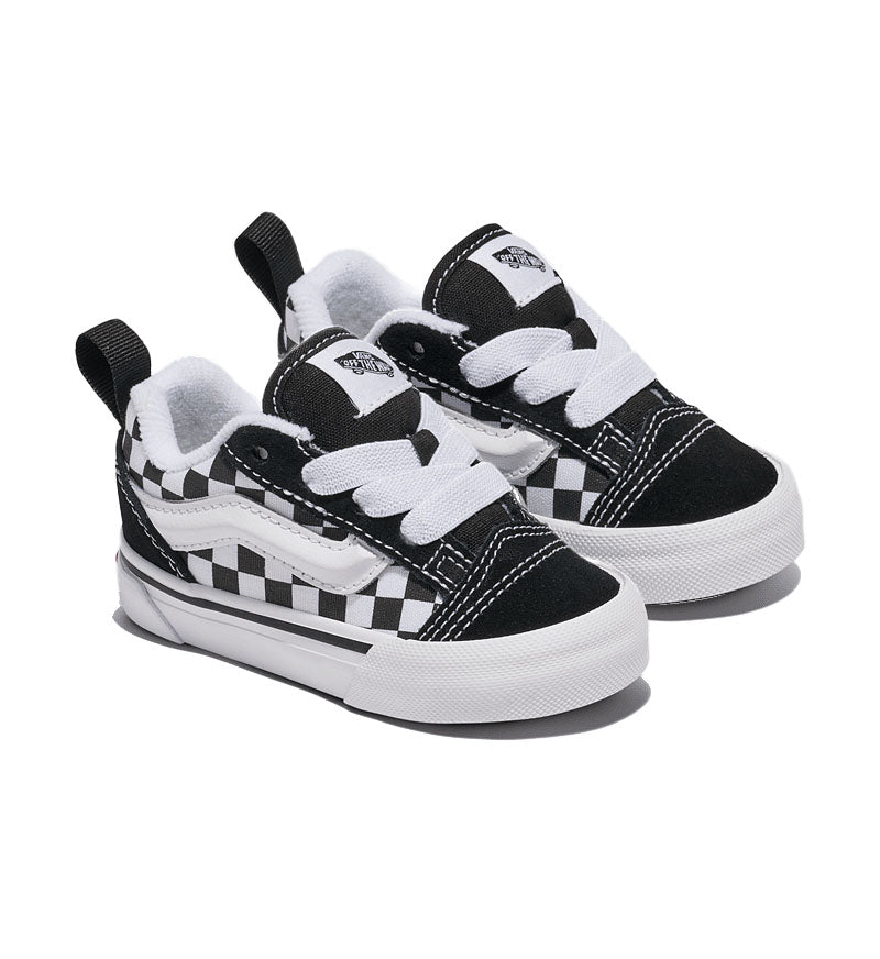 Pair of black and white checkered Vans Knu Skool toddler sneakers on a white background