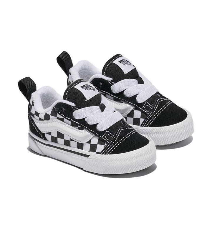 Pair of black and white checkered Vans Knu Skool toddler sneakers on a white background