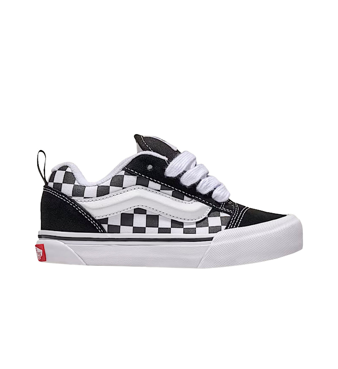 Black and white checkered sneaker with a red sole on a white background