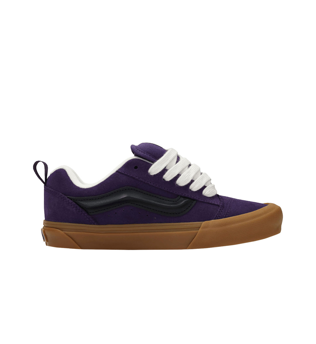Purple sneaker with brown sole on a white background