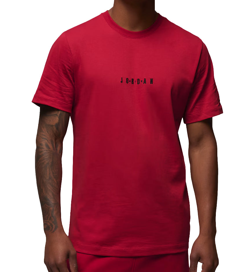 Red Jordan Air T-Shirt with black logo worn by a person on a white background