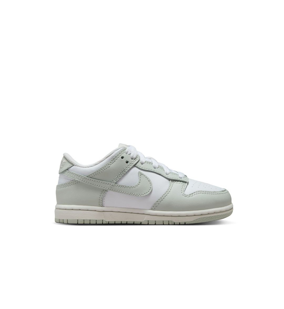 White and pearl green Nike Dunk sneaker with a Nike logo on a white background