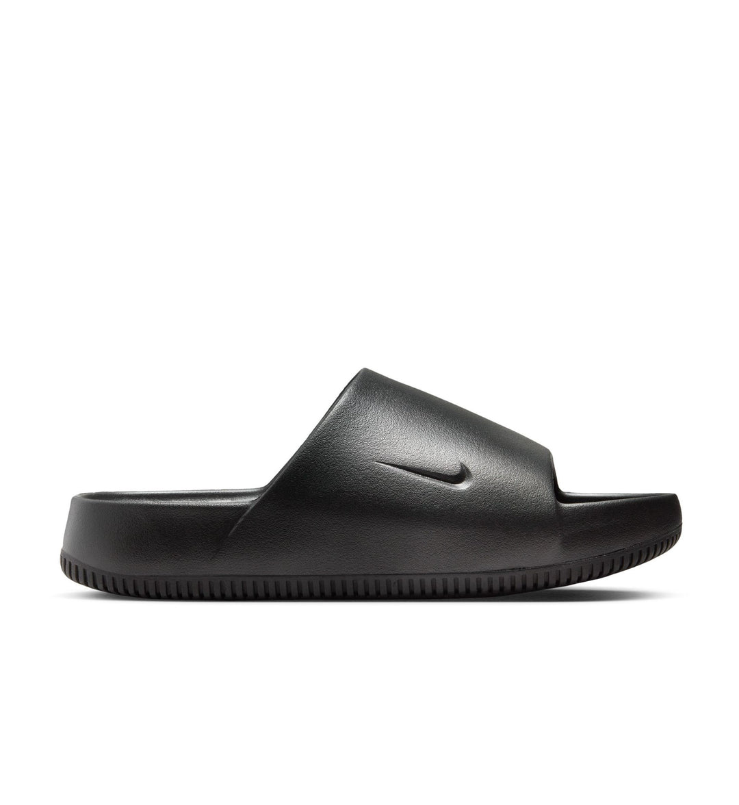 Black slide sandal with Nike logo on a white background