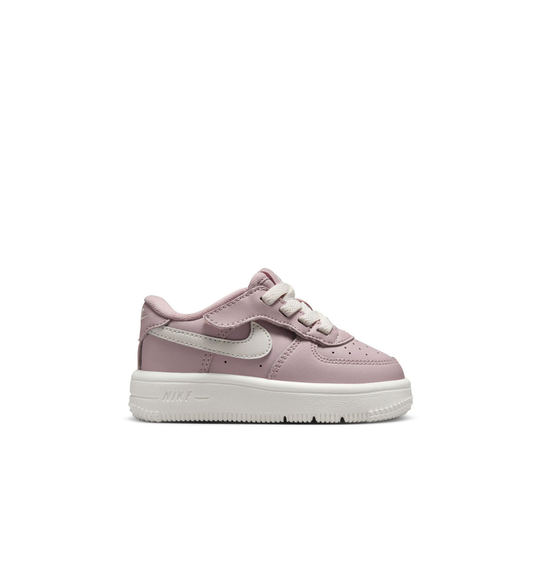 Pink Nike Air Force 1 toddler sneaker with a white logo on a white background