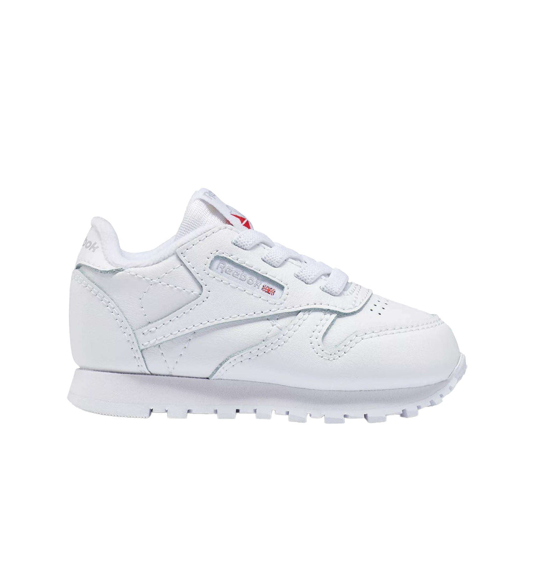 Toddler all white Reebok Classic Leather shoe on white background.