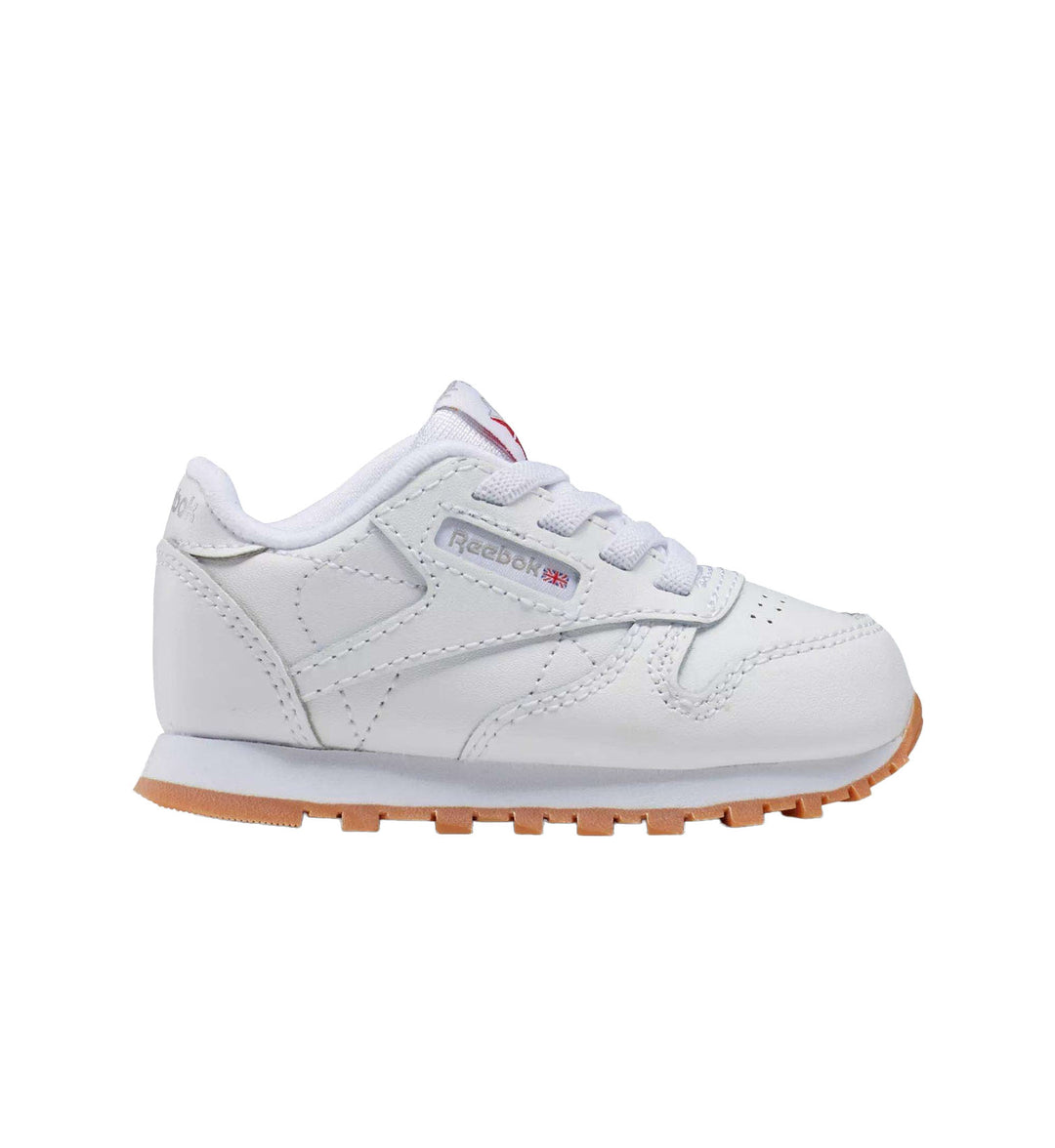 Toddler white and gum sole Reebok Classic Leather on white background.