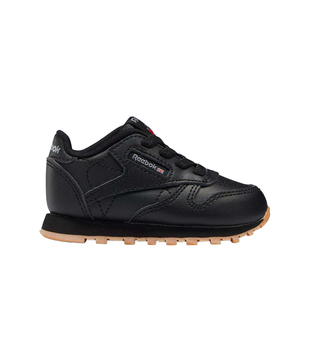 Black and gum sole Reebok Classic Leather shoe on white background.