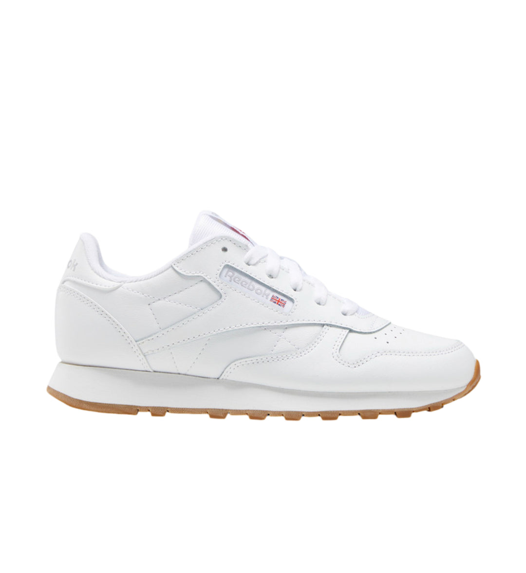 White and gum sole Reebok Classic Leather grade school on white background.