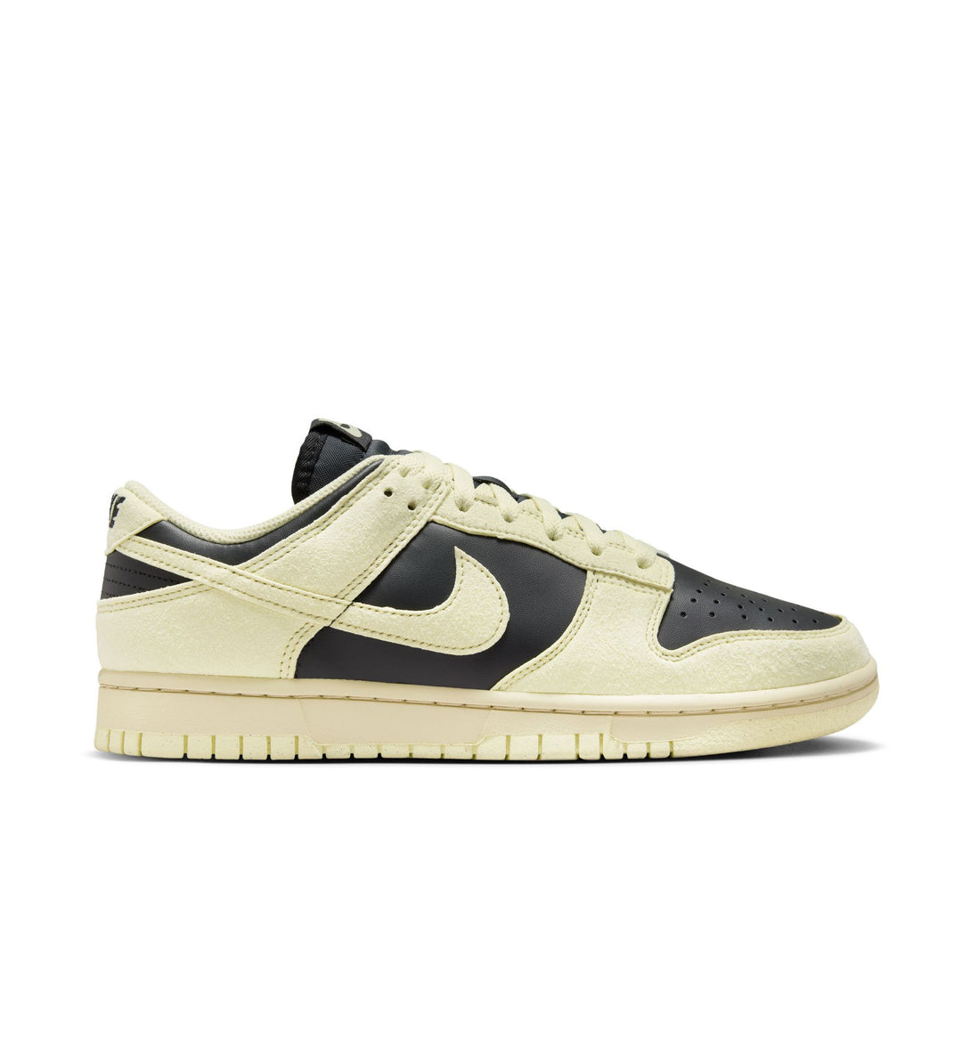 Sneaker with black swoosh logo on a light background