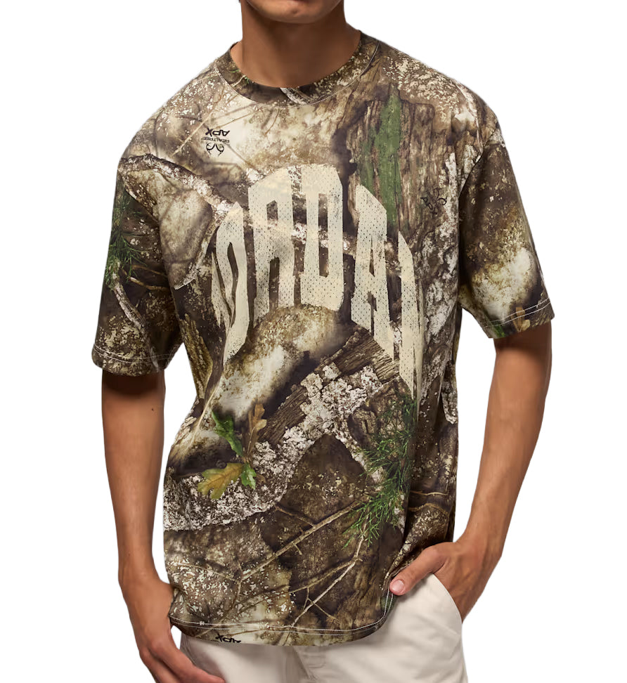 Person wearing a Realtree Camouflage Jordan Brooklyn T-Shirt with branding on a white background
