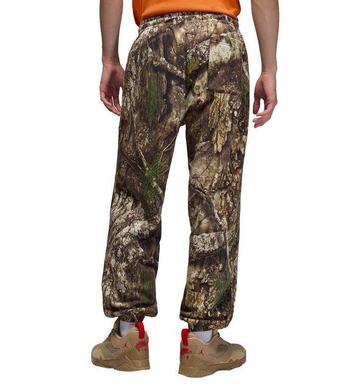 Jordan Brooklyn Fleece Realtree Pants worn by a person on a white background