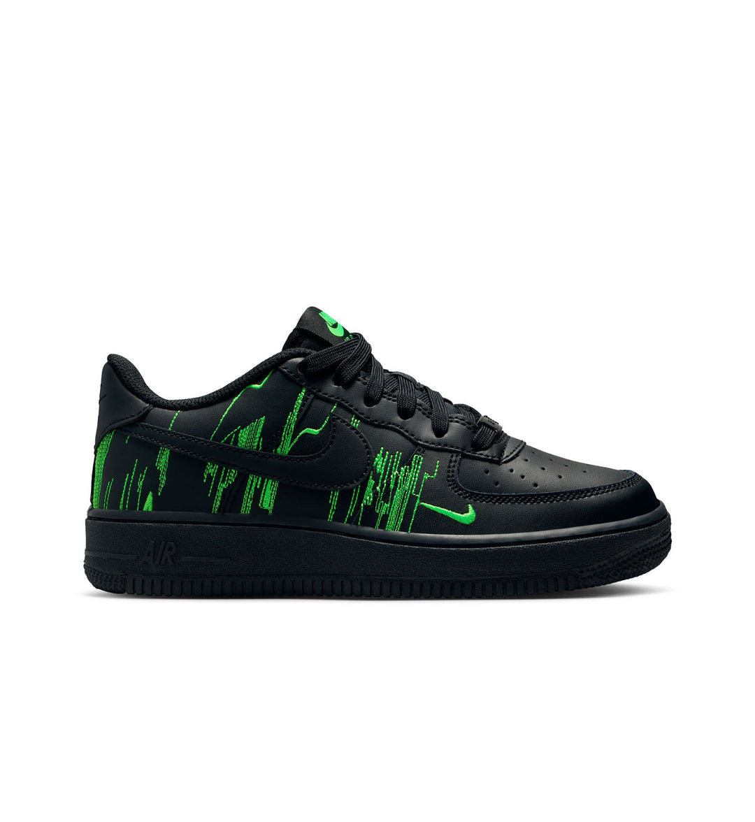 Black and green Nike Force 1 Low LV8 grade school shoe on white background.
