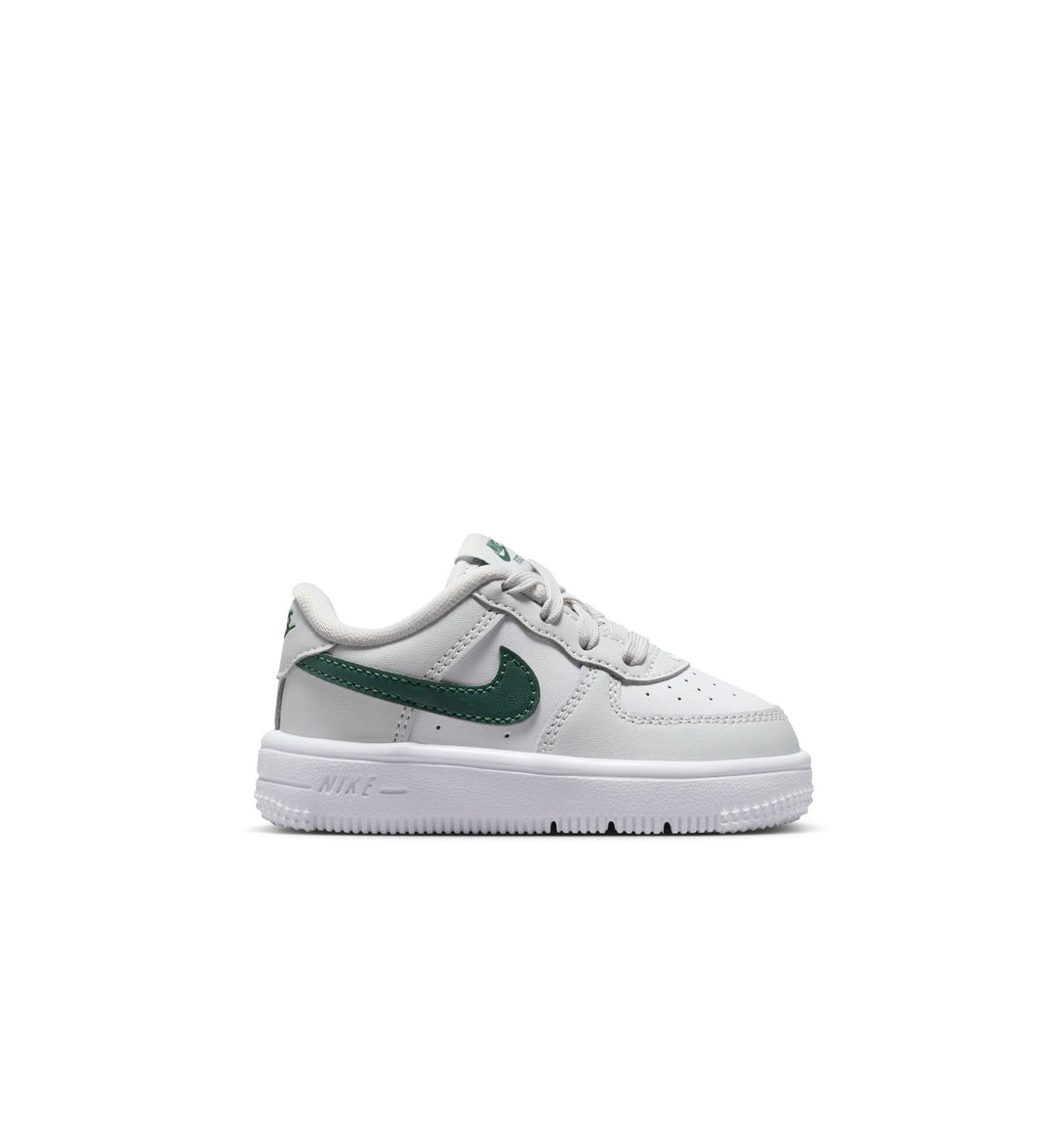 White Nike Air Force 1 Toddler sneaker with green accents on a white background
