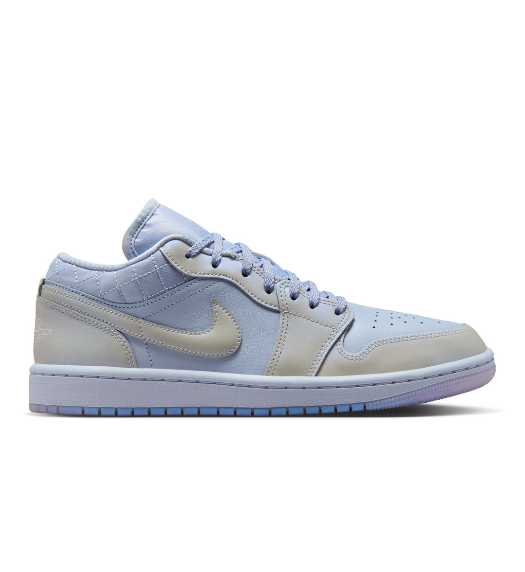 Light blue and platinum Air Jordan Retro 1 low sneaker on a white background.