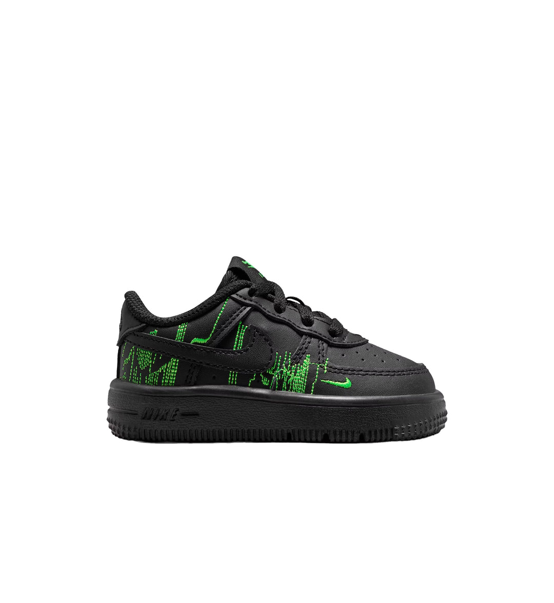 Black Nike Force 1 TD sneaker with green text and design on a white background