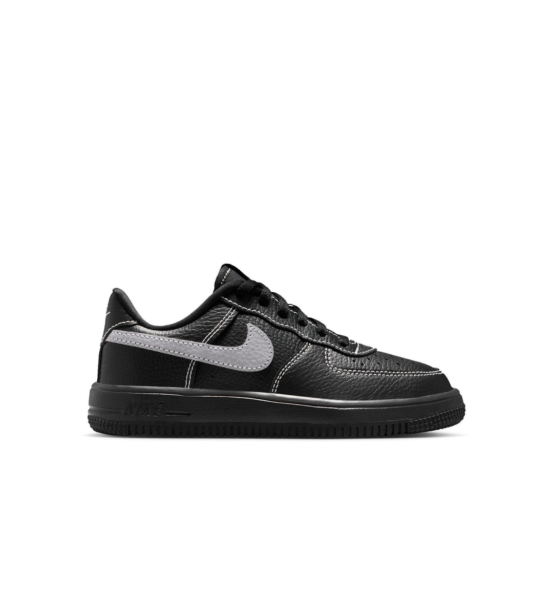 Black sneaker with a gray swoosh logo on a white background