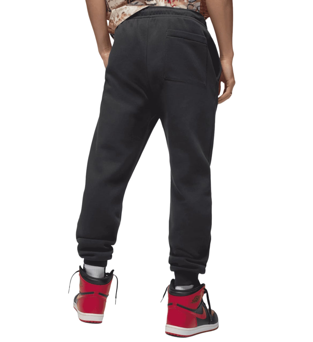 Person wearing black Jordan Jumpman Fleece Pants sweatpants on a white background