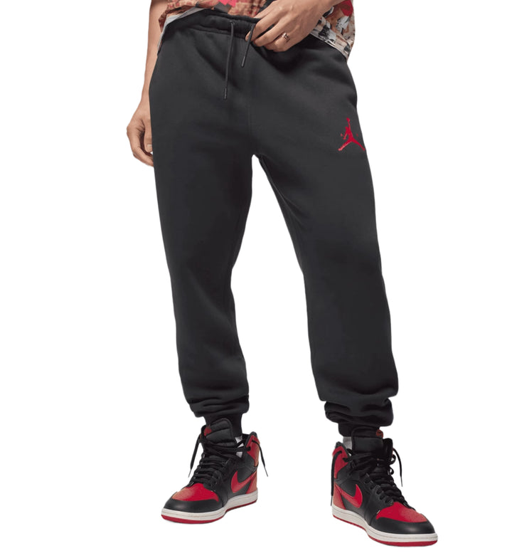 Person wearing black Jordan Jumpman Fleece sweatpants with a red logo on a white background