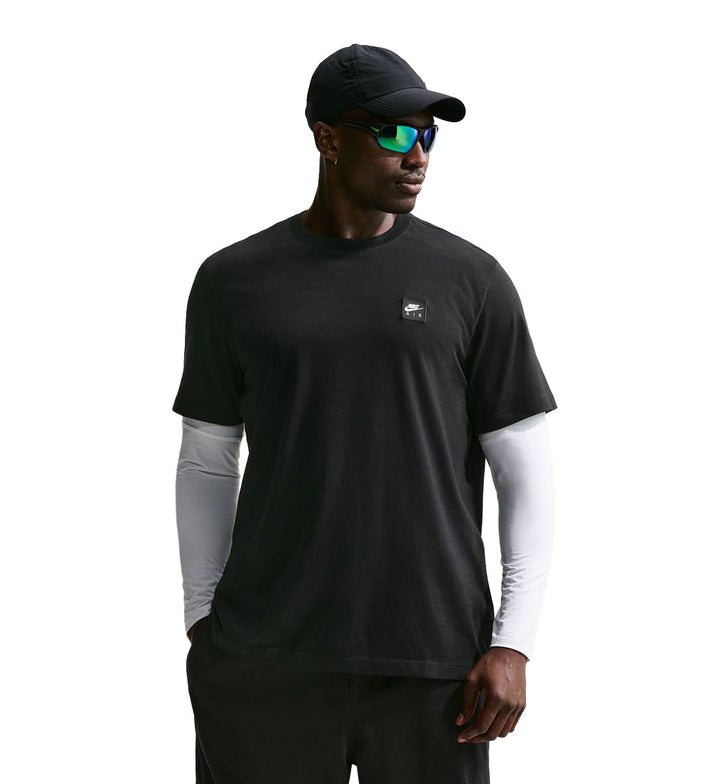 Man wearing a black Nike Sportswear T-Shirt  on a white background