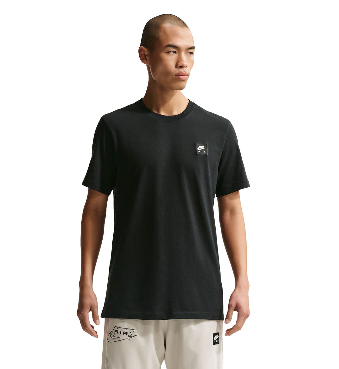 Person wearing a black Nike Sportswear T-Shirt  on a white background