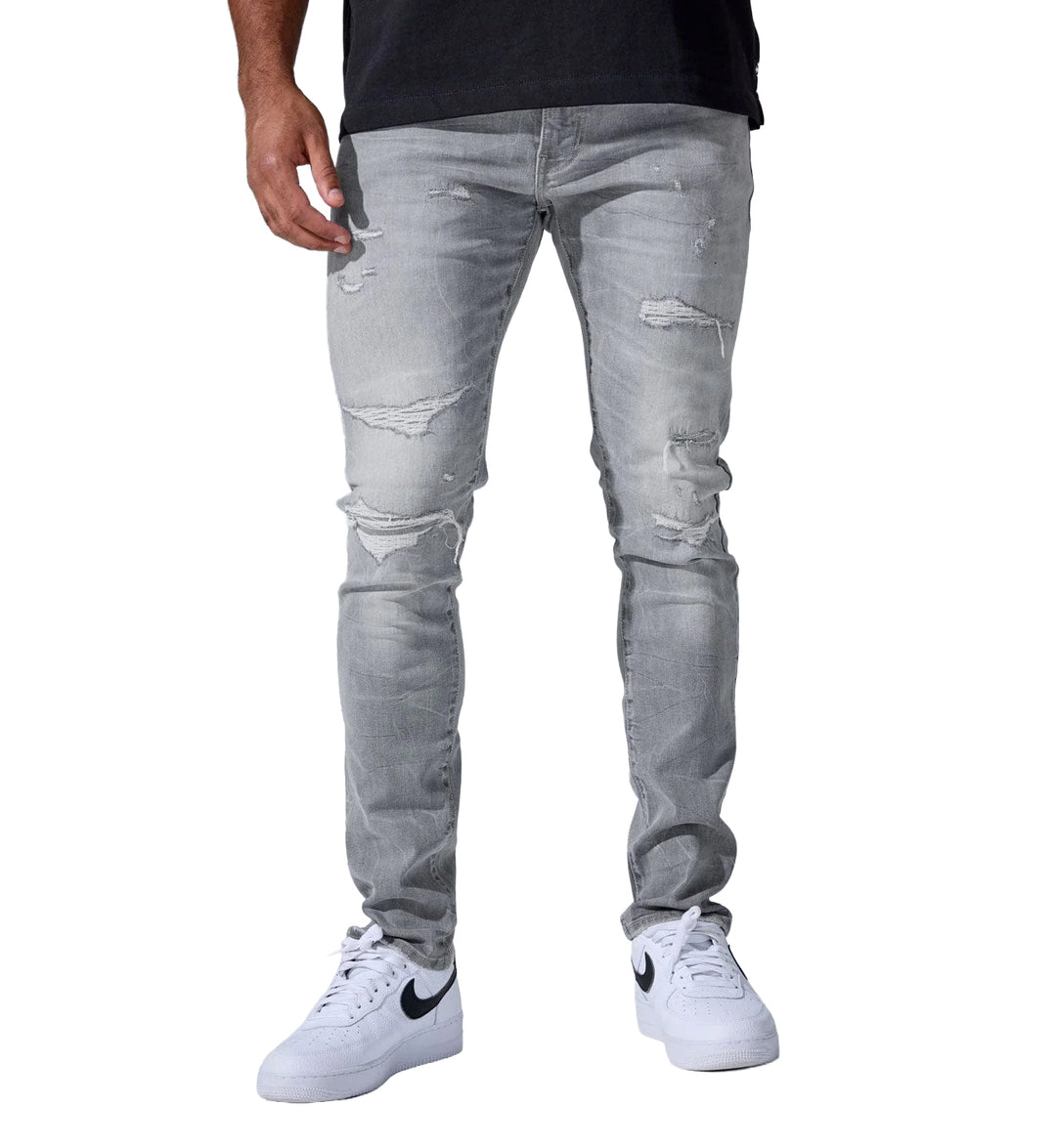 Person wearing gray Alexander Denim distressed jeans