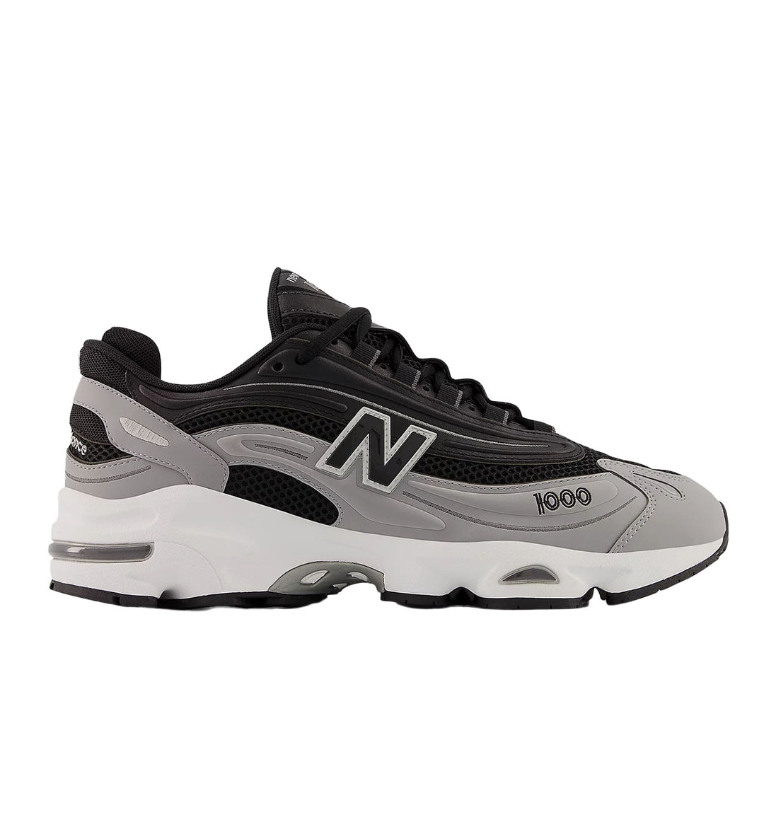 Black and gray sneaker with New Balance logo on a white background
