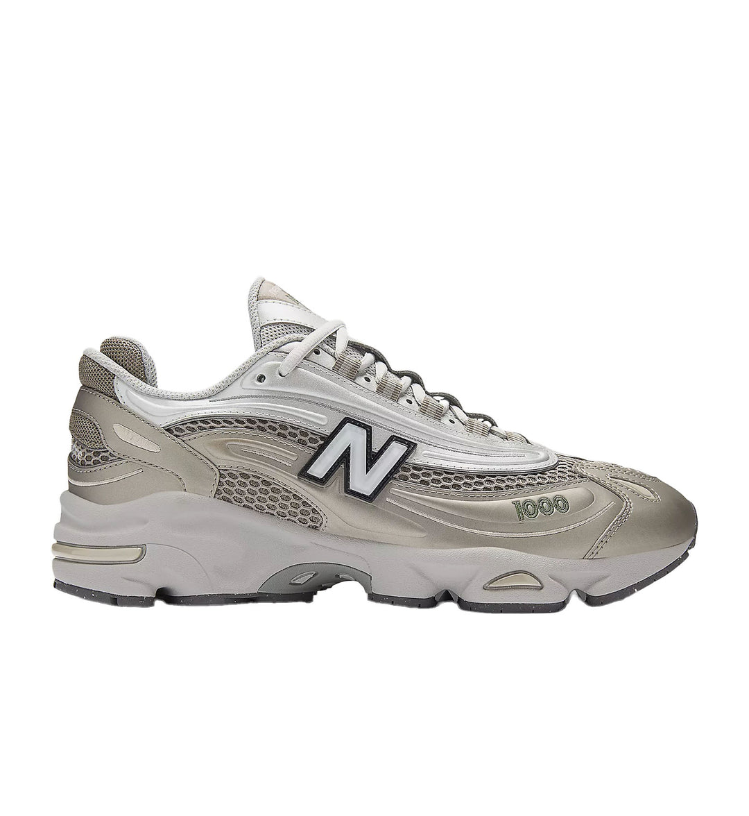 Gray and white sneaker with New Balance logo on a white background