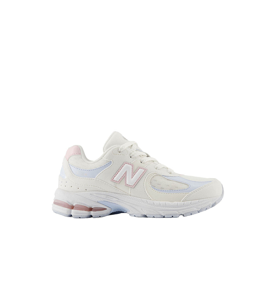 White sneaker with pink accents on a white background
