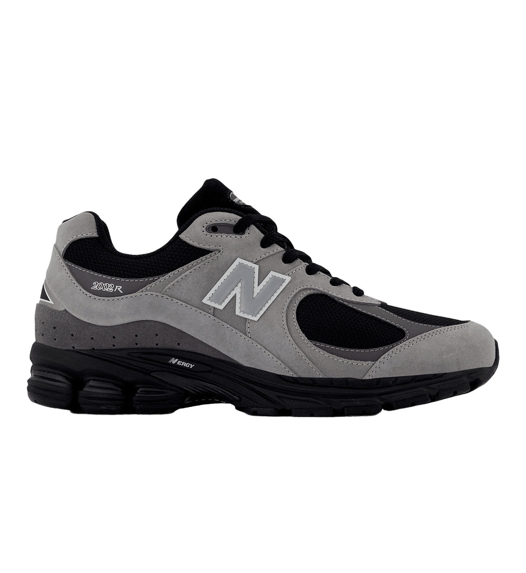 Gray and black New Balance 2002R sneaker with New Balance logo on a white background