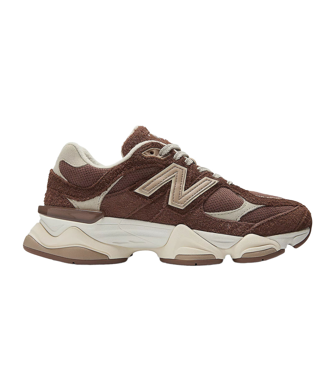 Brown sneaker with white accents on a white background