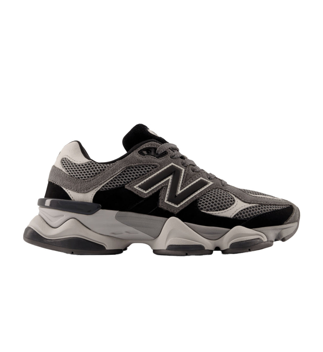 Gray and black sneaker with New Balance logo on a white background