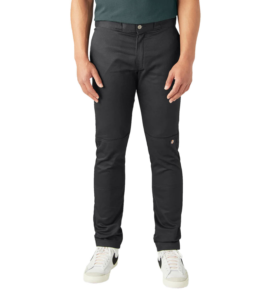 Person wearing black Dickies FLEX Skinny Fit Double Knee Work Pants on a white background