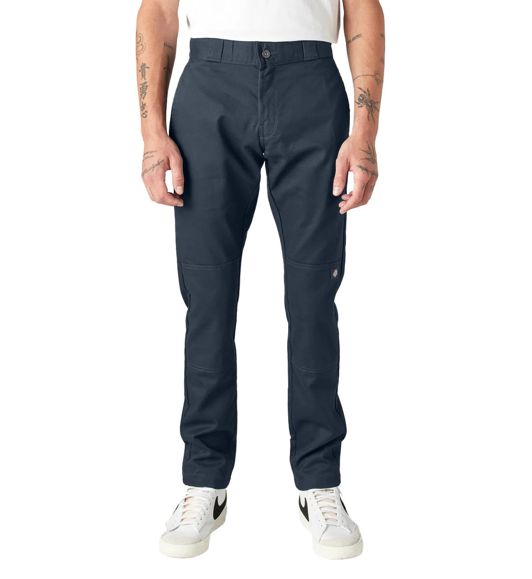 Person wearing navy Dickies FLEX Skinny Fit Double Knee Work Pants on a white background